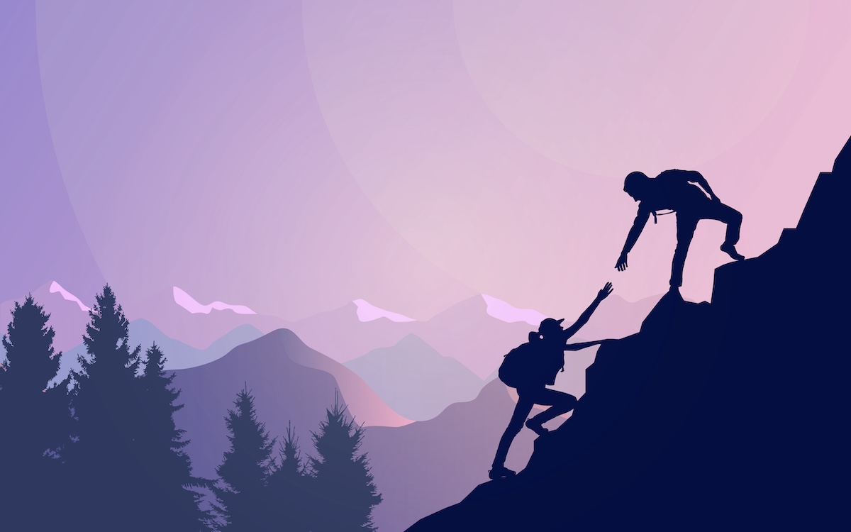 Image of a man helping other to climb the mountain